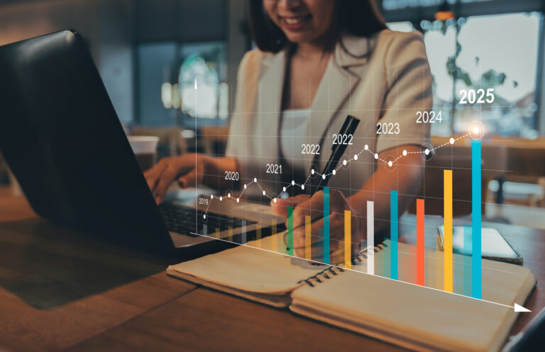woman working on a computer and increasing bar-graph representing ic group's long term growth strategy.